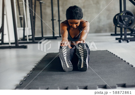 A beautiful black girl is engaged in a gym 58872861
