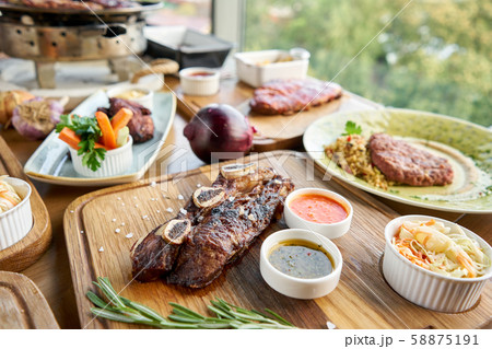 Beef meat cut according to the Argentine style, called asado. Barbecue restaurant menu. Many Beef meat cut according to the Argentine style, called asado. Barbecue restaurant menu. Many 58875191