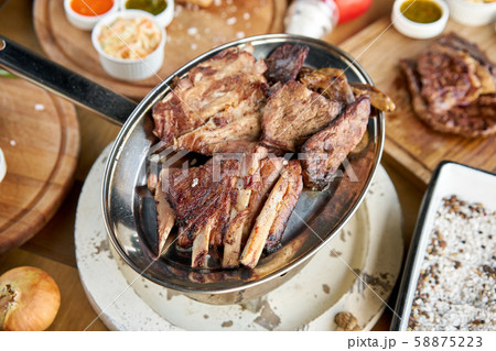 Various grilled meat set heated on coals. Barbecue restaurant menu. Many different food on the table 58875223