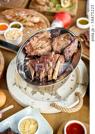 Various grilled meat set heated on coals. Barbecue restaurant menu. Many different food on the table 58875225
