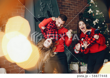 Family standing at home near christmas tree 58877448