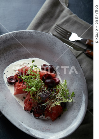 Watermelon salad with mozzarella, beautiful table setting, gray background, traditional Italian 58877965
