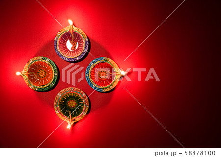 Happy Diwali - Clay Diya lamps lit Hindu festival of lights celebration 58878100