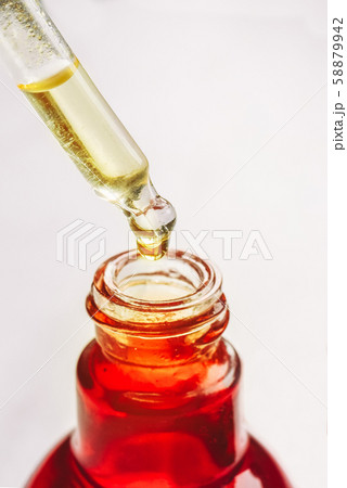Drop of oil, serum in a dropper closeup. Skin care concept. 58879942