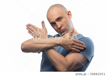 Photo of young shaved man with arms crossed on white background 58882051