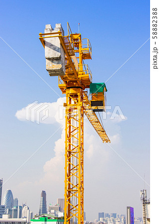 Crane is used in the construction of high buildings for tool of large industry under the blue sky and white clouds. 58882388