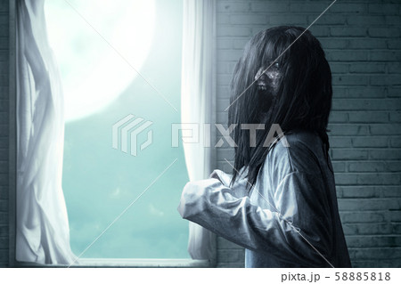 A scary ghost woman with blood and an angry face A scary ghost woman with blood and an angry face 58885818