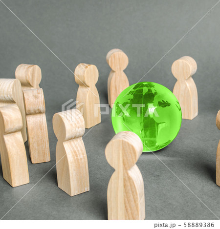 People surrounded a green Globe world planet earth. Cooperation and collaboration of people around the world. Outsourcing and joint work on projects. Diplomacy. crowdfunding. Preserving environment 58889386