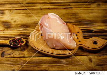 Raw chicken breast on cutting board 58890188