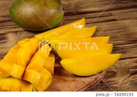 Fresh mango fruit on wooden table 58890193