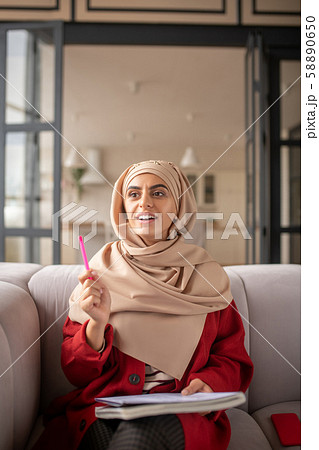 Pretty Muslim girl thinking about ideas for her essay Pretty Muslim girl thinking about ideas for her essay 58890650
