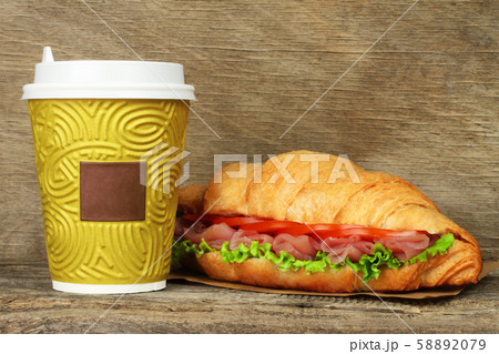 Big croissant with green salad, tomatoes and pork Big croissant with green salad, tomatoes and pork 58892079