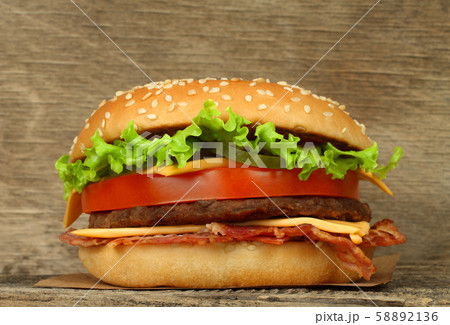 Big hamburger on wooden background Big hamburger on wooden background 58892136
