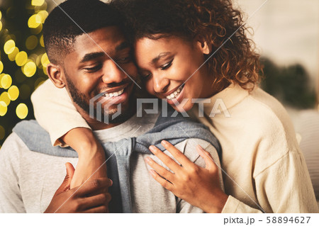 Loving afro couple spending christmas eve together Loving afro couple spending christmas eve together 58894627