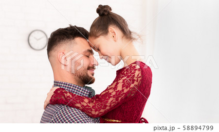 Loving dad embracing his cute little daughter at home 58894799