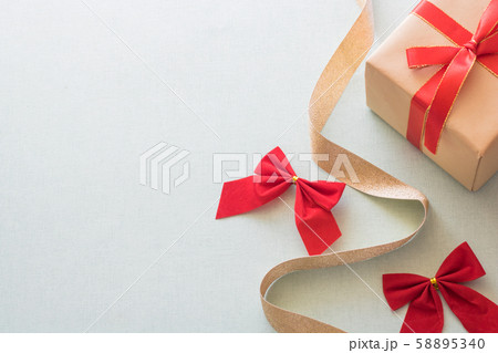 Christmas background with gift boxes, pine cone and decorations on light blue background. Preparation for holidays. Top view with copy space. Christmas background with gift boxes, pine cone and decorations on light blue background. Preparation for holidays. Top view with copy space. 58895340