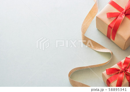 Christmas background with gift boxes, pine cone and decorations on light blue background. Preparation for holidays. Top view with copy space. Christmas background with gift boxes, pine cone and decorations on light blue background. Preparation for holidays. Top view with copy space. 58895341