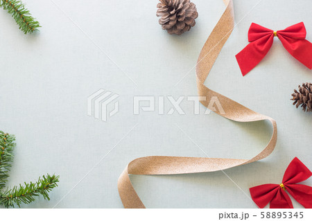 Christmas background with gift boxes, pine cone and decorations on light blue background. Preparation for holidays. Top view with copy space. Christmas background with gift boxes, pine cone and decorations on light blue background. Preparation for holidays. Top view with copy space. 58895345