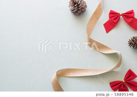 Christmas background with gift boxes, pine cone and decorations on light blue background. Preparation for holidays. Top view with copy space. Christmas background with gift boxes, pine cone and decorations on light blue background. Preparation for holidays. Top view with copy space. 58895346