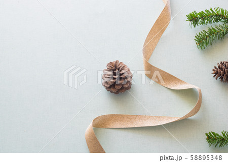 Christmas background with gift boxes, pine cone and decorations on light blue background. Preparation for holidays. Top view with copy space. 58895348