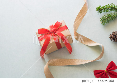 Christmas background with gift boxes, pine cone and decorations on light blue background. Preparation for holidays. Top view with copy space. Christmas background with gift boxes, pine cone and decorations on light blue background. Preparation for holidays. Top view with copy space. 58895368