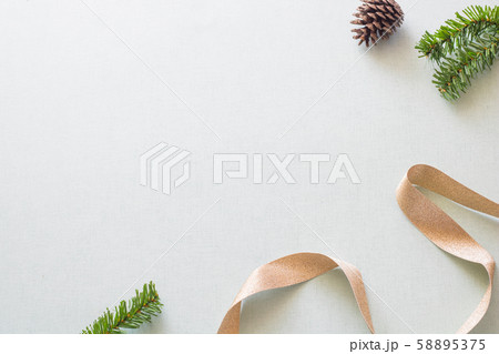Christmas background with gift boxes, pine cone and decorations on light blue background. Preparation for holidays. Top view with copy space. 58895375