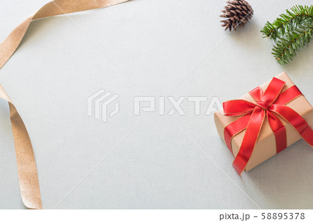 Christmas background with gift boxes, pine cone and decorations on light blue background. Preparation for holidays. Top view with copy space. Christmas background with gift boxes, pine cone and decorations on light blue background. Preparation for holidays. Top view with copy space. 58895378
