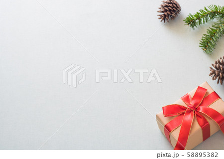 Christmas background with gift boxes, pine cone and decorations on light blue background. Preparation for holidays. Top view with copy space. Christmas background with gift boxes, pine cone and decorations on light blue background. Preparation for holidays. Top view with copy space. 58895382