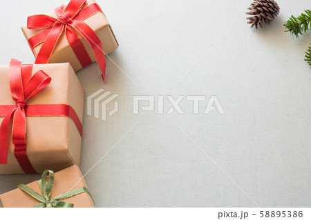Christmas background with gift boxes, pine cone and decorations on light blue background. Preparation for holidays. Top view with copy space. Christmas background with gift boxes, pine cone and decorations on light blue background. Preparation for holidays. Top view with copy space. 58895386