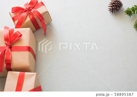 Christmas background with gift boxes, pine cone and decorations on light blue background. Preparation for holidays. Top view with copy space. Christmas background with gift boxes, pine cone and decorations on light blue background. Preparation for holidays. Top view with copy space. 58895387