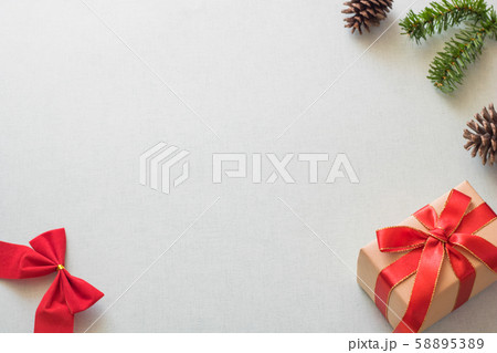 Christmas background with gift boxes, pine cone and decorations on light blue background. Preparation for holidays. Top view with copy space. Christmas background with gift boxes, pine cone and decorations on light blue background. Preparation for holidays. Top view with copy space. 58895389