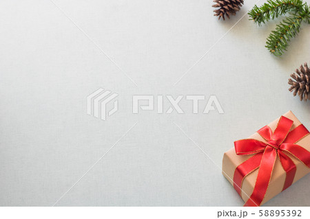 Christmas background with gift boxes, pine cone and decorations on light blue background. Preparation for holidays. Top view with copy space. Christmas background with gift boxes, pine cone and decorations on light blue background. Preparation for holidays. Top view with copy space. 58895392