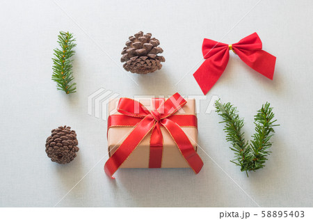 Christmas background with gift boxes, pine cone and decorations on light blue background. Preparation for holidays. Top view with copy space. 58895403