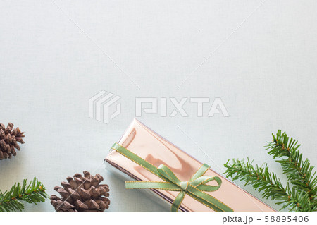 Christmas background with gift boxes, pine cone and decorations on light blue background. Preparation for holidays. Top view with copy space. Christmas background with gift boxes, pine cone and decorations on light blue background. Preparation for holidays. Top view with copy space. 58895406