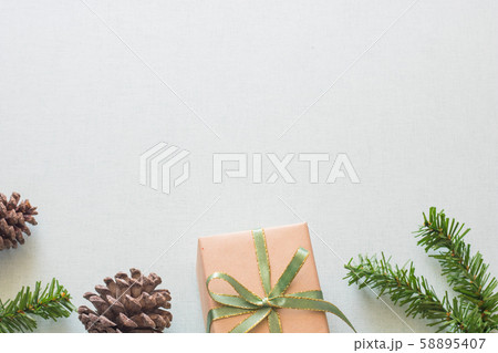 Christmas background with gift boxes, pine cone and decorations on light blue background. Preparation for holidays. Top view with copy space. Christmas background with gift boxes, pine cone and decorations on light blue background. Preparation for holidays. Top view with copy space. 58895407