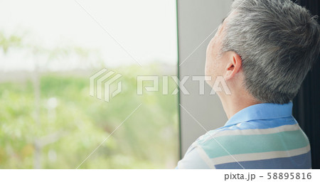 elder man look through window elder man look through window 58895816