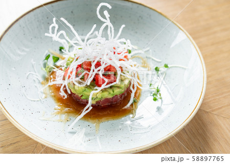 Tartar with tuna in the restaurant. Variety of dishes on the table. Italian cuisine 58897765