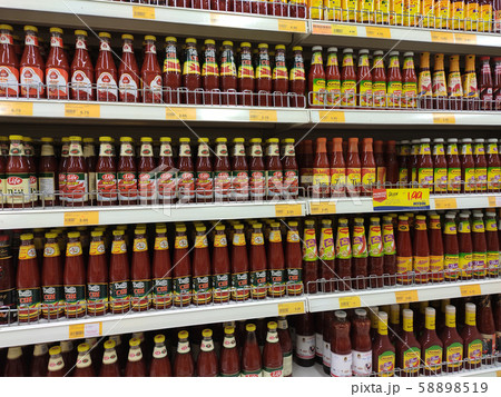 Selective focused variety of cooking sauce in the bottles displayed for sale in the supermarkets. Displayed on racks and separated by the brand to facilitate buyers. Selective focused variety of cooking sauce in the bottles displayed for sale in the supermarkets. Displayed on racks and separated by the brand to facilitate buyers. 58898519