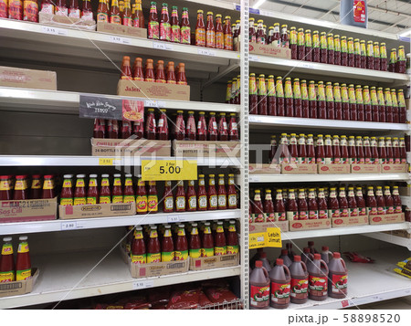 Selective focused variety of cooking sauce in the bottles displayed for sale in the supermarkets. Displayed on racks and separated by the brand to facilitate buyers. Selective focused variety of cooking sauce in the bottles displayed for sale in the supermarkets. Displayed on racks and separated by the brand to facilitate buyers. 58898520