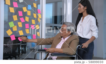 Medical concepts. An elderly man writing a comment Medical concepts. An elderly man writing a comment 58899030