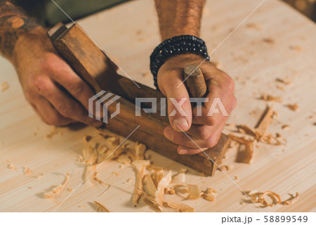 Portrait of a young male carpenter who works in his workshop. Portrait of a young male carpenter who works in his workshop. 58899549