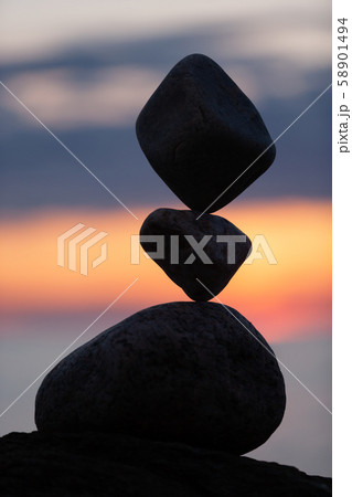 balanced stones on the beach at sunset balanced stones on the beach at sunset 58901494