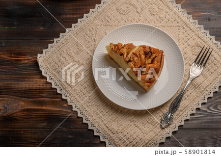 Piece of traditional homemade cornwall pie on a plate on linen napkin 58901814