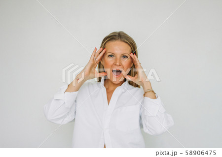 Portrait of surprised blonde forty year woman Portrait of surprised blonde forty year woman 58906475