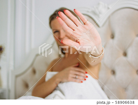Happy smiling beautiful long hair young woman ulling hand towards camera 58906638
