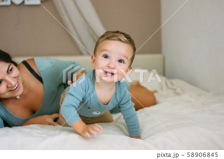 Charming happy little baby boy having fun with mom Charming happy little baby boy having fun with mom 58906845