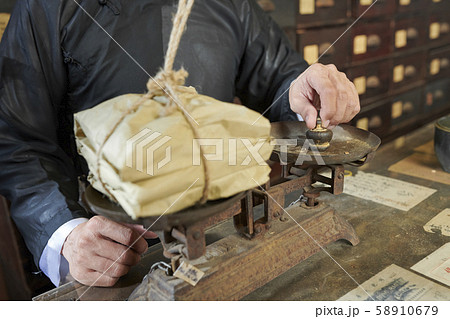 Traditional Asian apothecary worker weighting package Traditional Asian apothecary worker weighting package 58910679