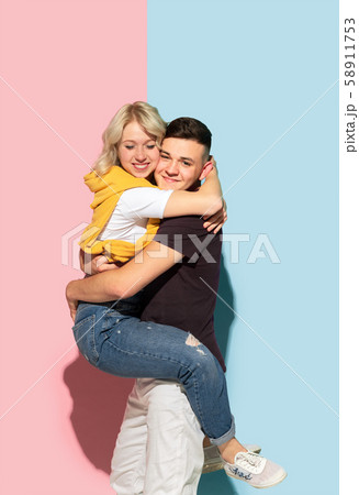 Young emotional man and woman on pink and blue background 58911753