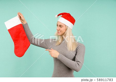 A beautiful sexy girl in a New Year's hat and gray 58911783