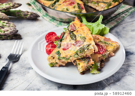 Frittata made of eggs, asparagus and tomatoes Frittata made of eggs, asparagus and tomatoes 58912460